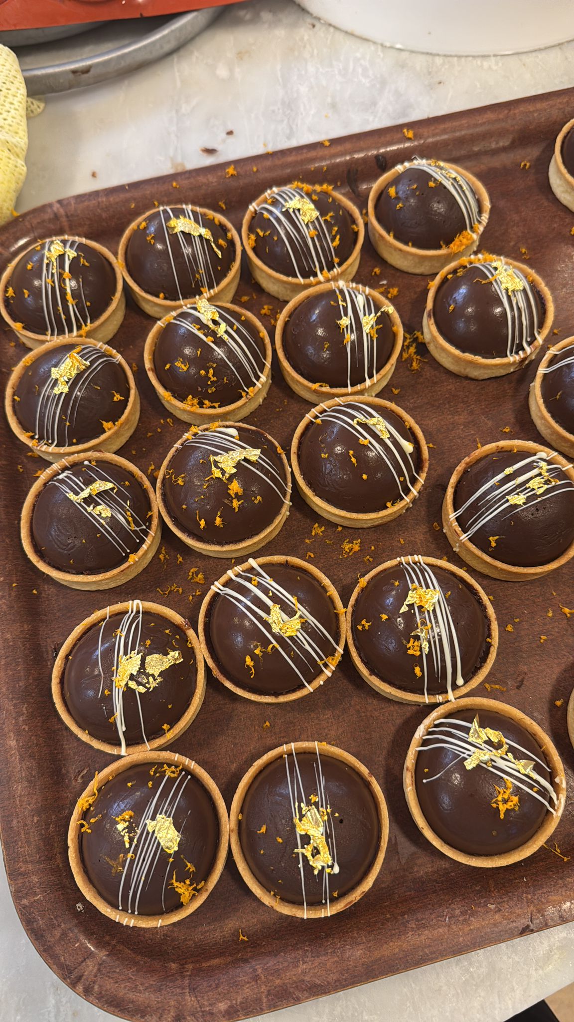 Chocolate dome tarts with gold leaf