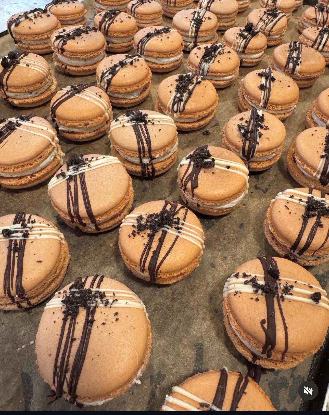 Rows of chocolate drizzle macarons