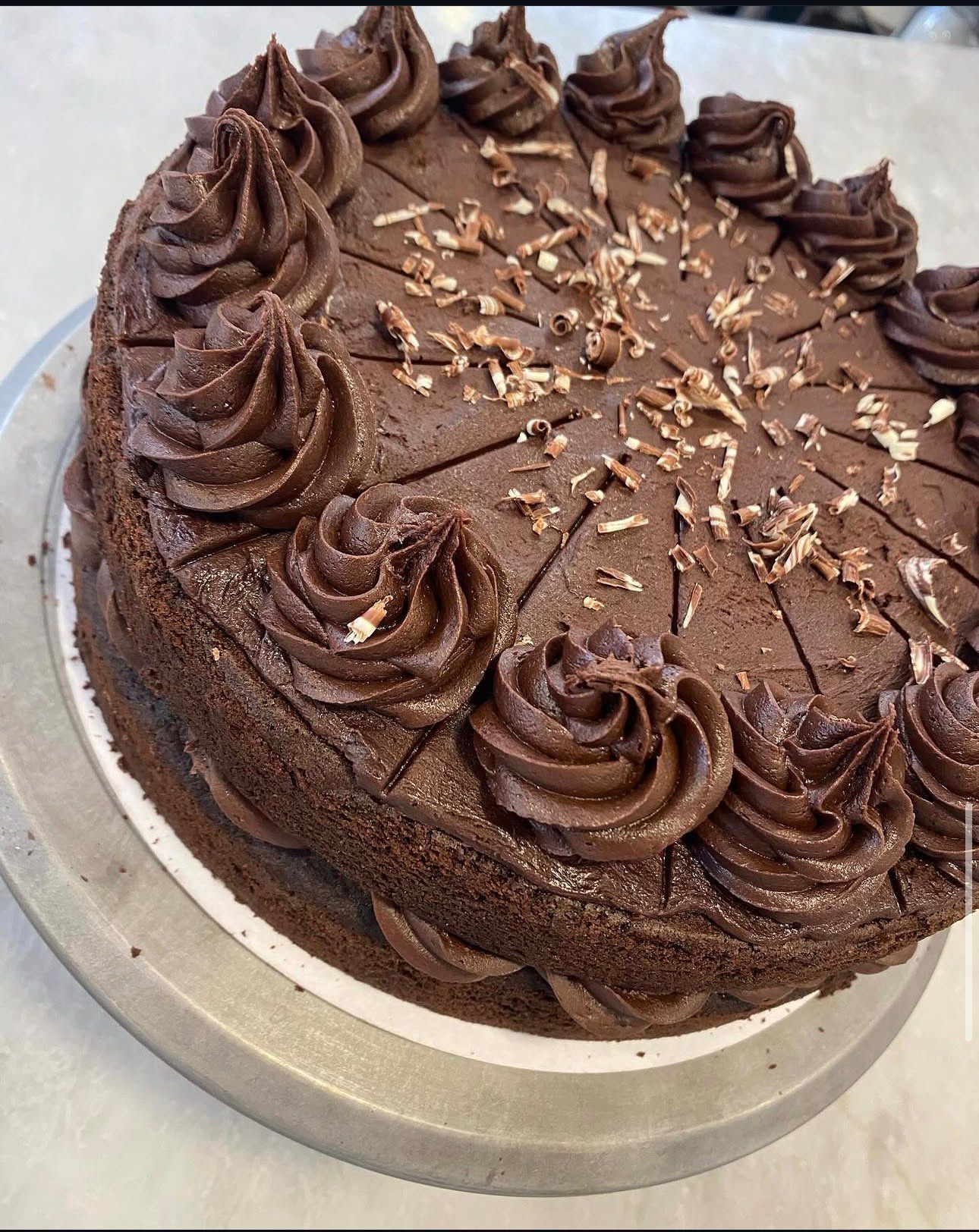 Rich chocolate ganache cake with rosette piping