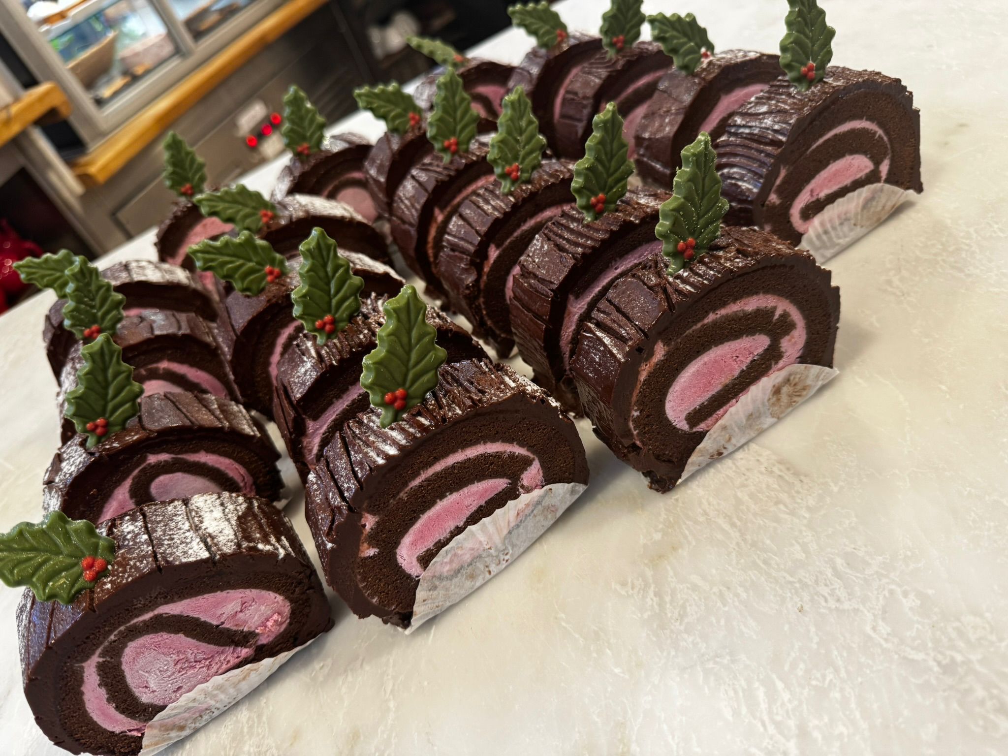 Chocolate yule logs with holly decoration